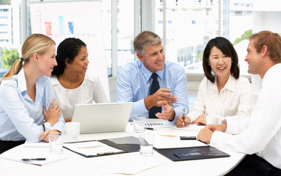A group of people sitting around a table.