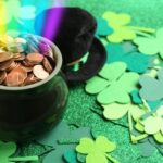 A pot of gold sitting on top of green paper.