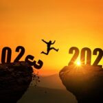A person jumping over the year 2 0 2 1