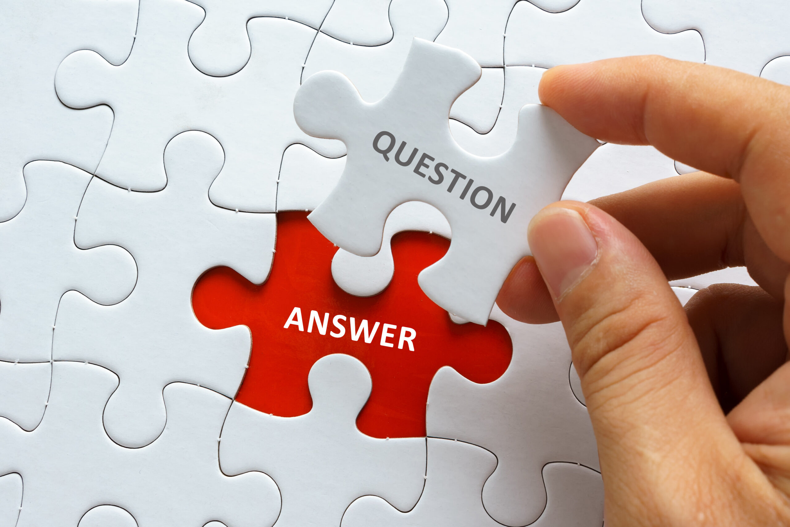 Hand,Holding,Piece,Of,Jigsaw,Puzzle,With,Word,Question,Answer.