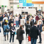 A crowd of people walking around in an airport.